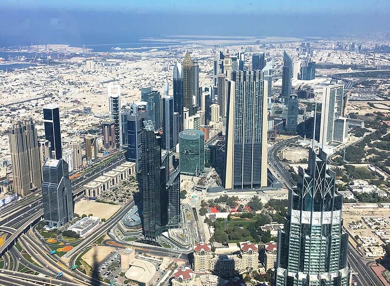 View over Dubai and DIFC from the top of Burj Khalifa View from top of Burj Khalifa with view over DIFC in Dubai and Sheikh Zayed Road